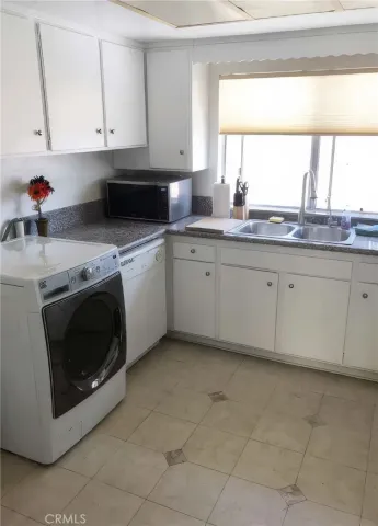 a kitchen with granite countertop a sink and a stove