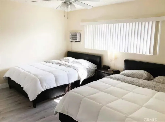 a bedroom with two beds and a chandelier