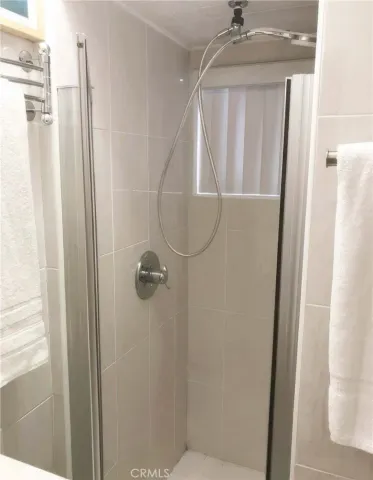 a bathroom with a glass door shower