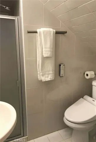 a bathroom with a toilet and a shower