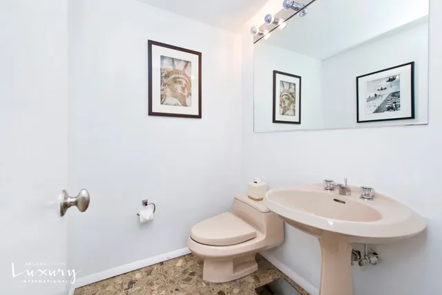 a bathroom with a toilet sink and mirror