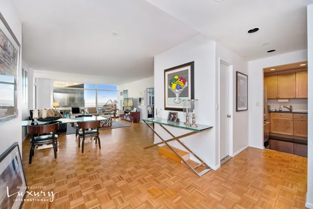 a living room with furniture a dining table and kitchen view