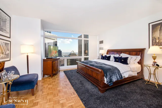 a large bedroom with a bed and window