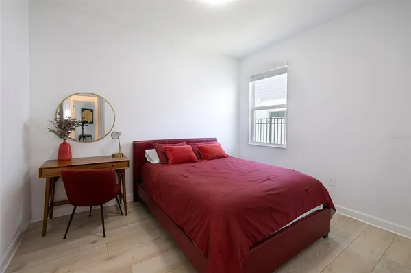 a dining room with furniture a chandelier and window