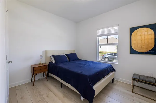 a bedroom with a bed and a window