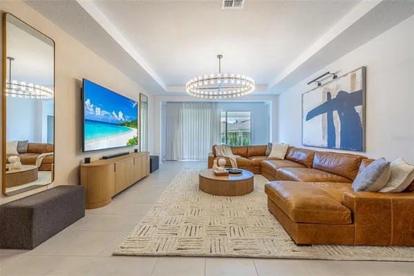 a bedroom with a bed and a chandelier