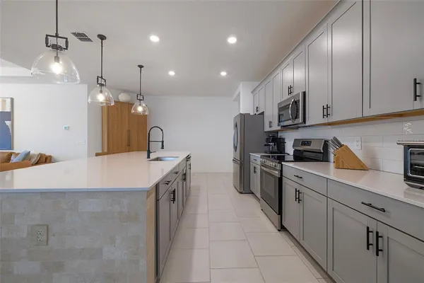a bathroom with a granite countertop sink a toilet and bathtub