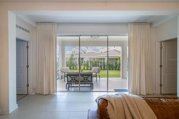 an aerial view of ocean and residential houses with outdoor space