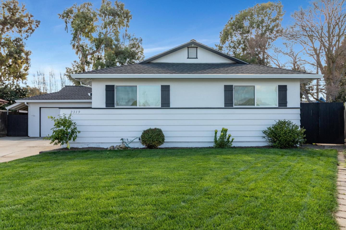 a view of a house with a yard and a garden