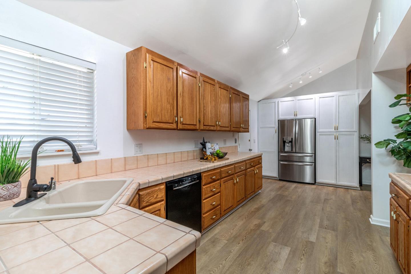 2319 Cimarron Drive Santa Clara, CA 95051 - Photo 14 of 42 a kitchen with stainless steel appliances granite countertop a sink a stove a refrigerator cabinets a dining table and chairs