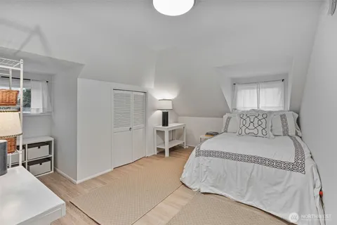 a bedroom with a bed and a lamp