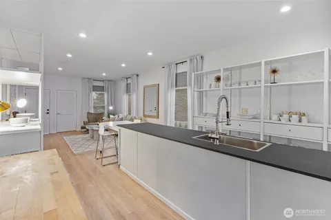 a large kitchen with a large counter top furniture a sink and appliances