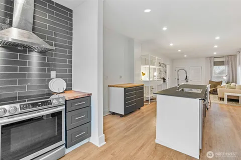 a kitchen with stainless steel appliances granite countertop a stove and a refrigerator