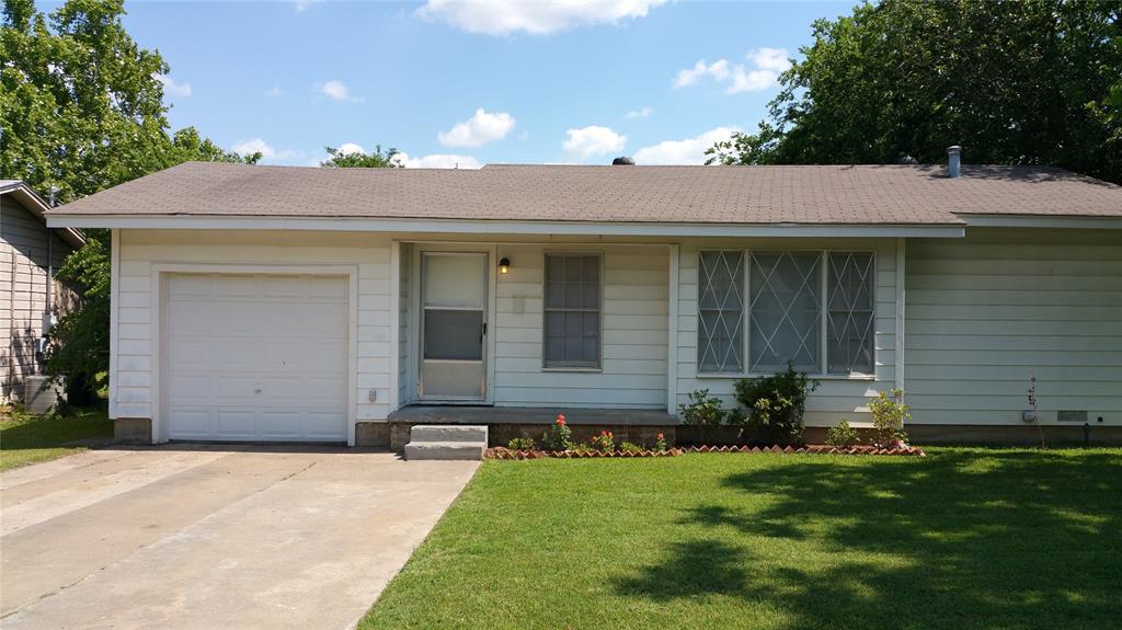 Single story home featuring a garage and a front yard