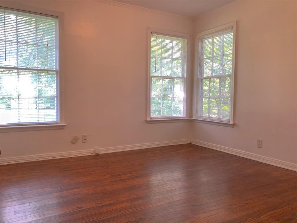 527 Euclid Street Cleburne, TX 76033 - Photo 7 of 8 Spare room featuring dark hardwood / wood-style flooring and a wealth of natural light