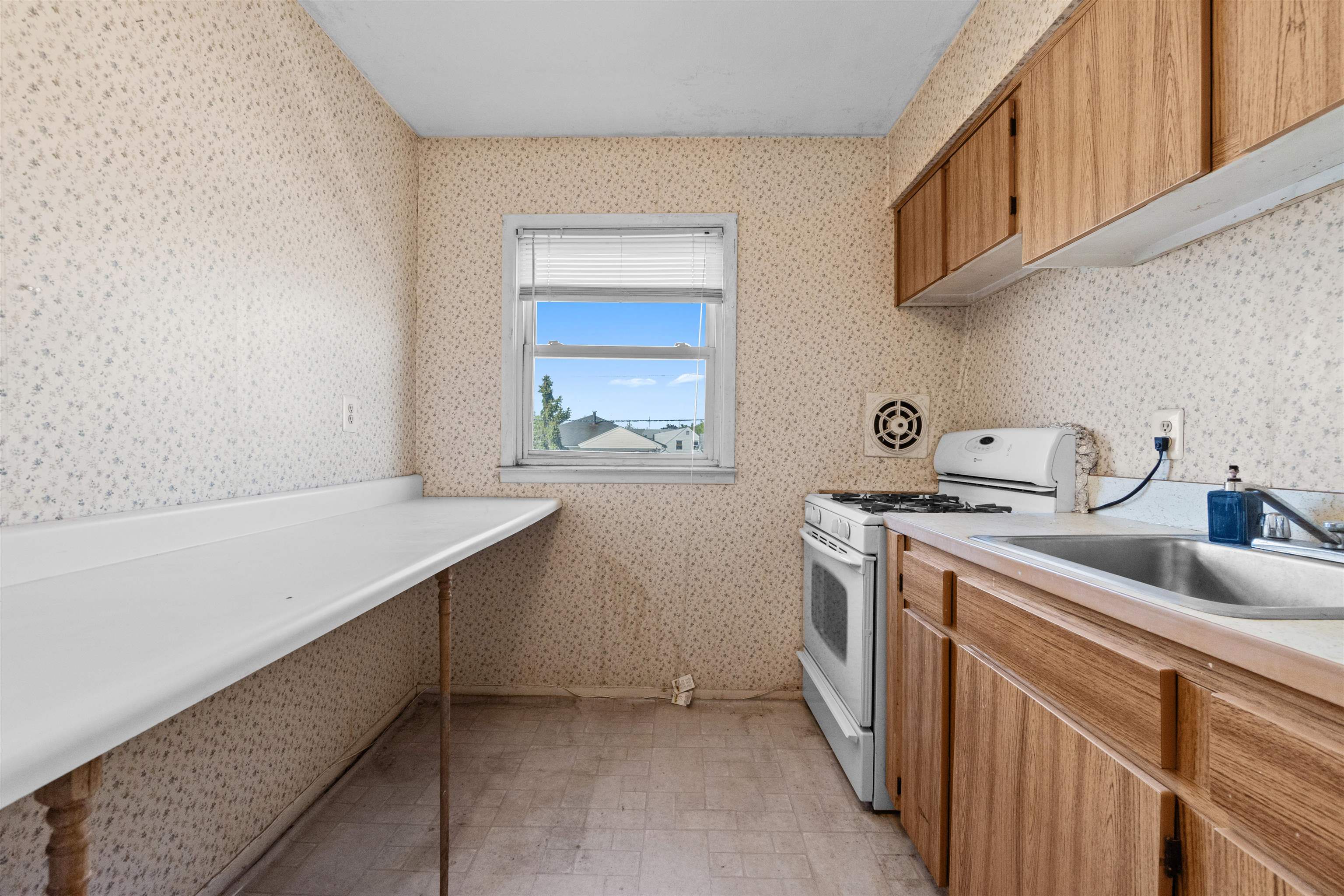 13 Crossgate Road Jersey City, NJ 07305 - Photo 16 of 36 a kitchen with a sink stove and cabinets