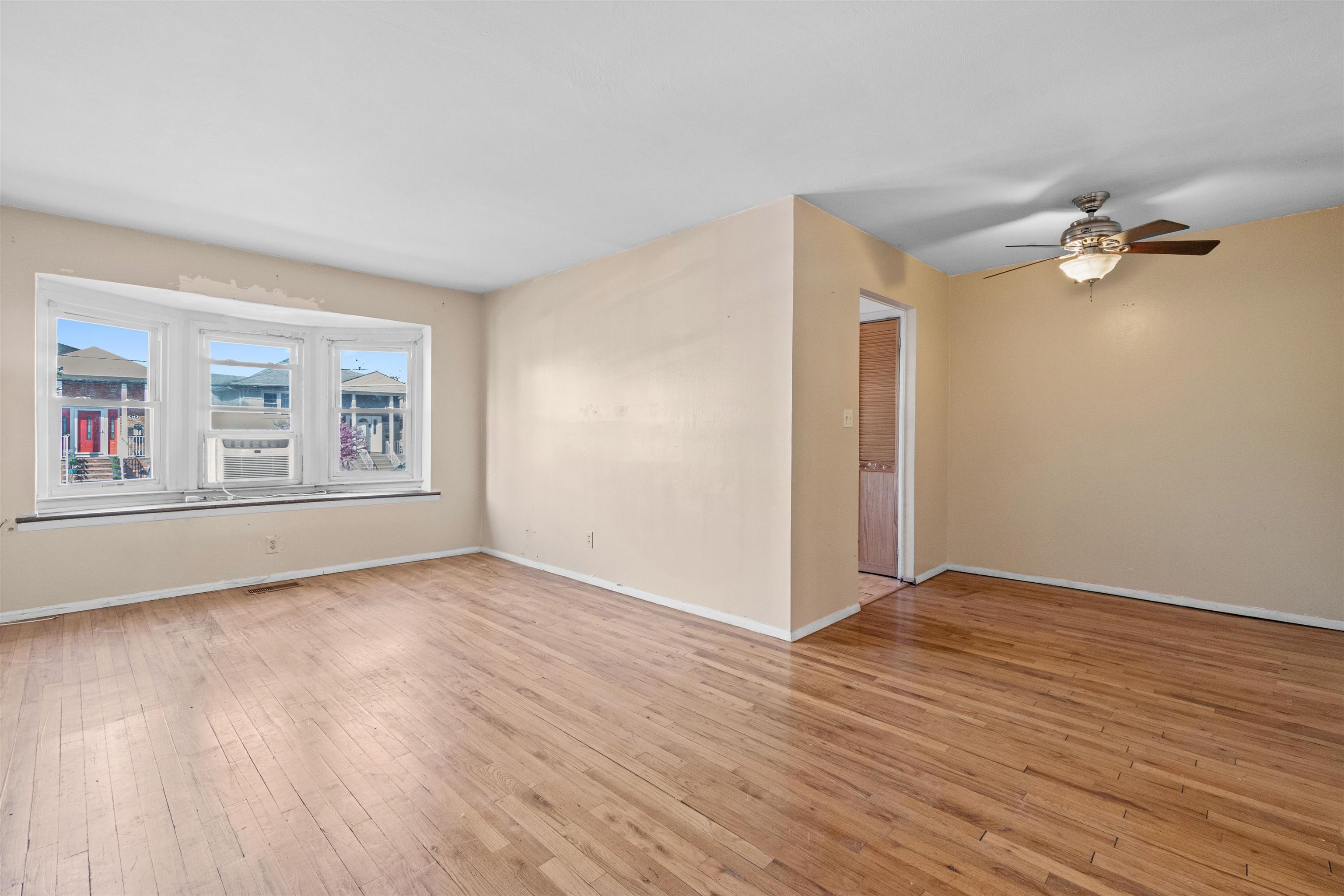 13 Crossgate Road Jersey City, NJ 07305 - Photo 2 of 36 wooden floor in an empty room with a window