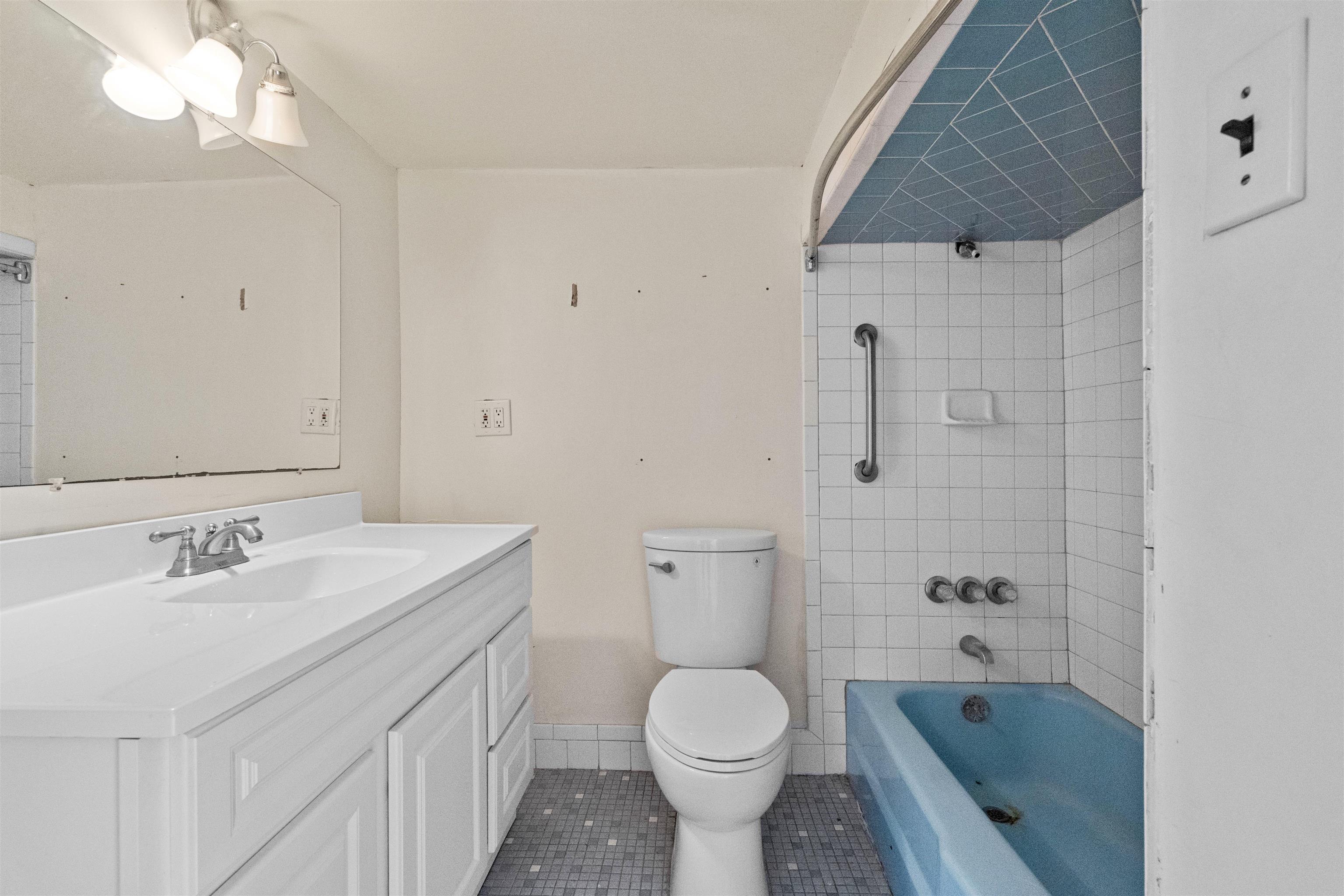 13 Crossgate Road Jersey City, NJ 07305 - Photo 25 of 36 a bathroom with a sink a toilet and shower