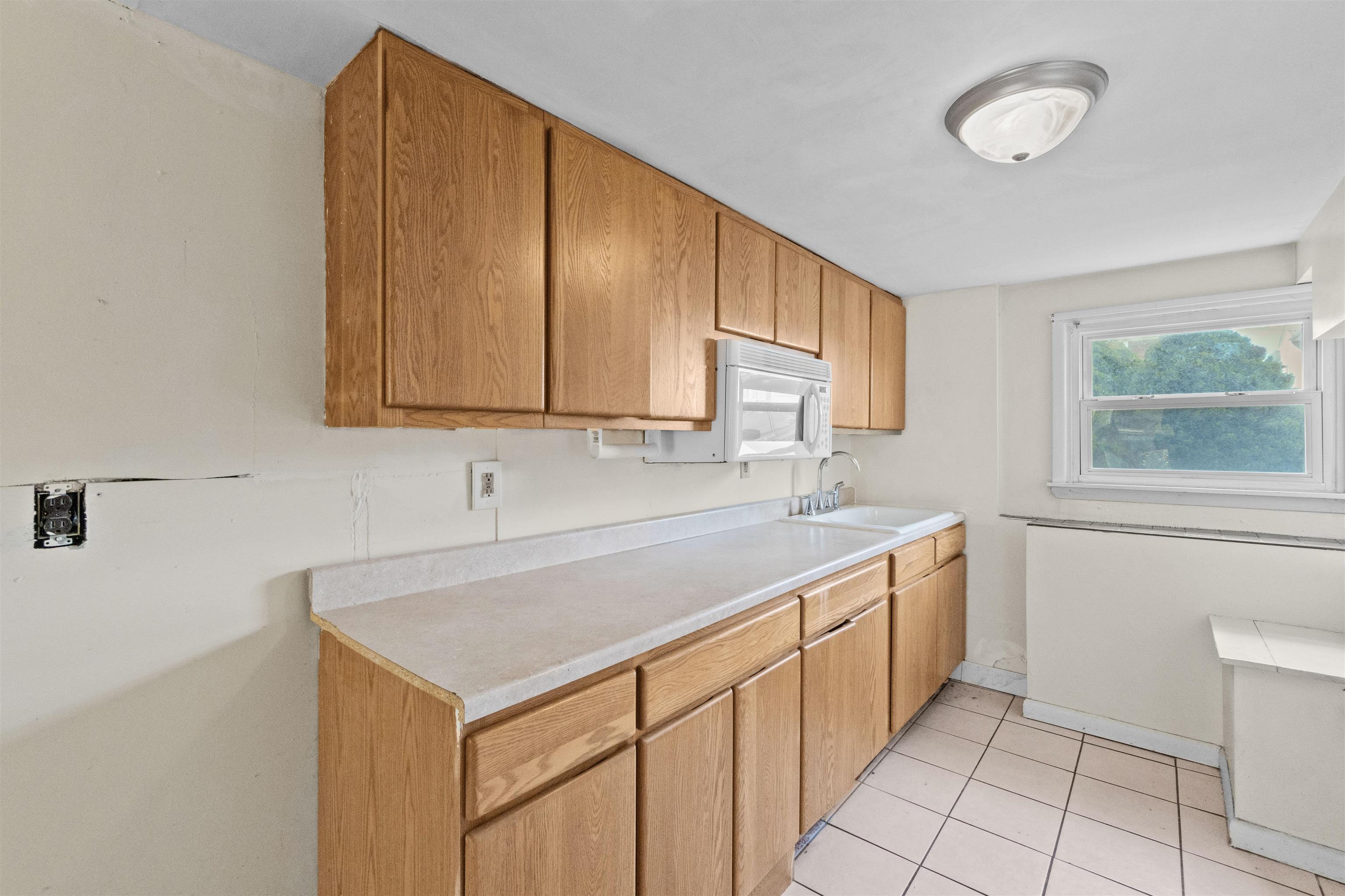 13 Crossgate Road Jersey City, NJ 07305 - Photo 29 of 36 a kitchen with a sink cabinets and window