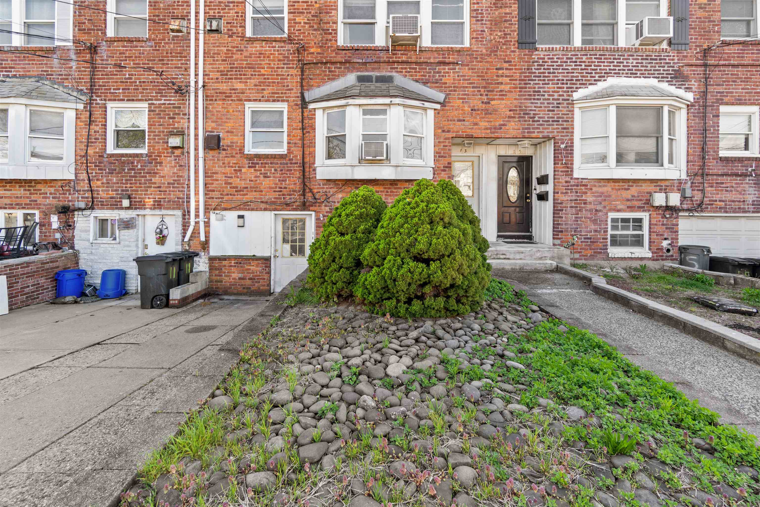 13 Crossgate Road Jersey City, NJ 07305 - Photo 32 of 36 front view of a brick house with a yard