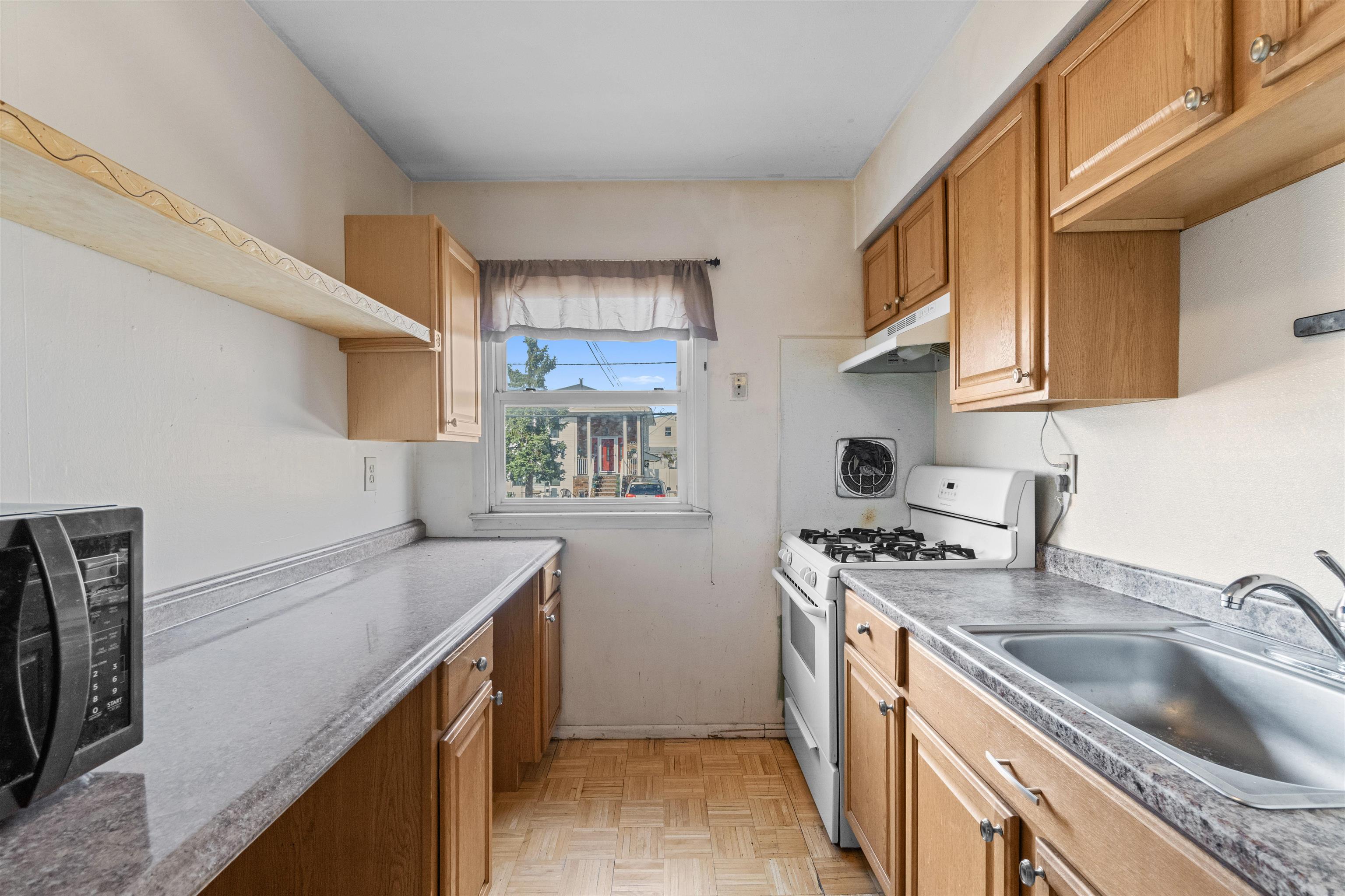 13 Crossgate Road Jersey City, NJ 07305 - Photo 5 of 36 a kitchen with stainless steel appliances granite countertop a sink stove and cabinets