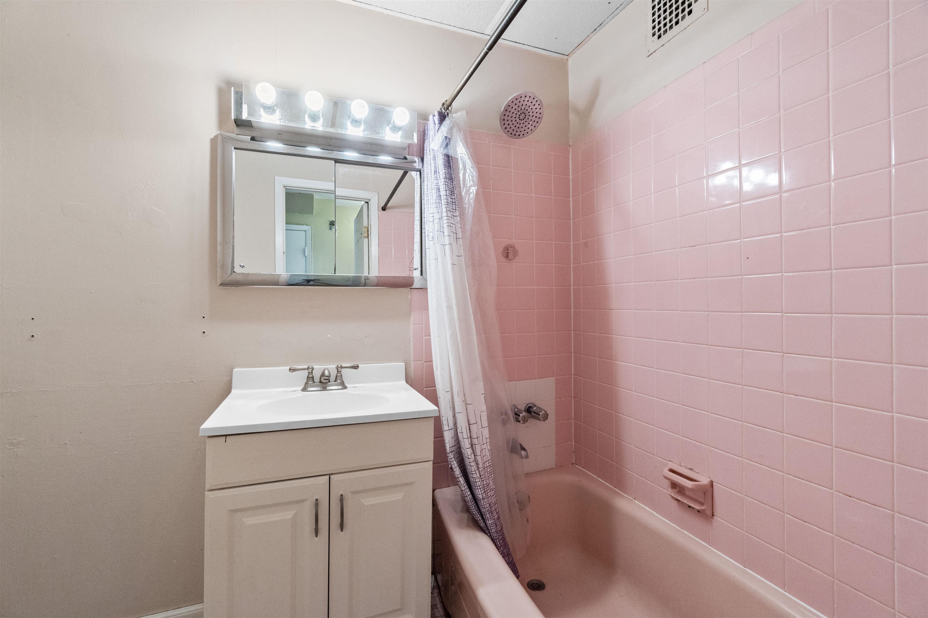 13 Crossgate Road Jersey City, NJ 07305 - Photo 6 of 36 a bathroom with a sink a vanity and a mirror