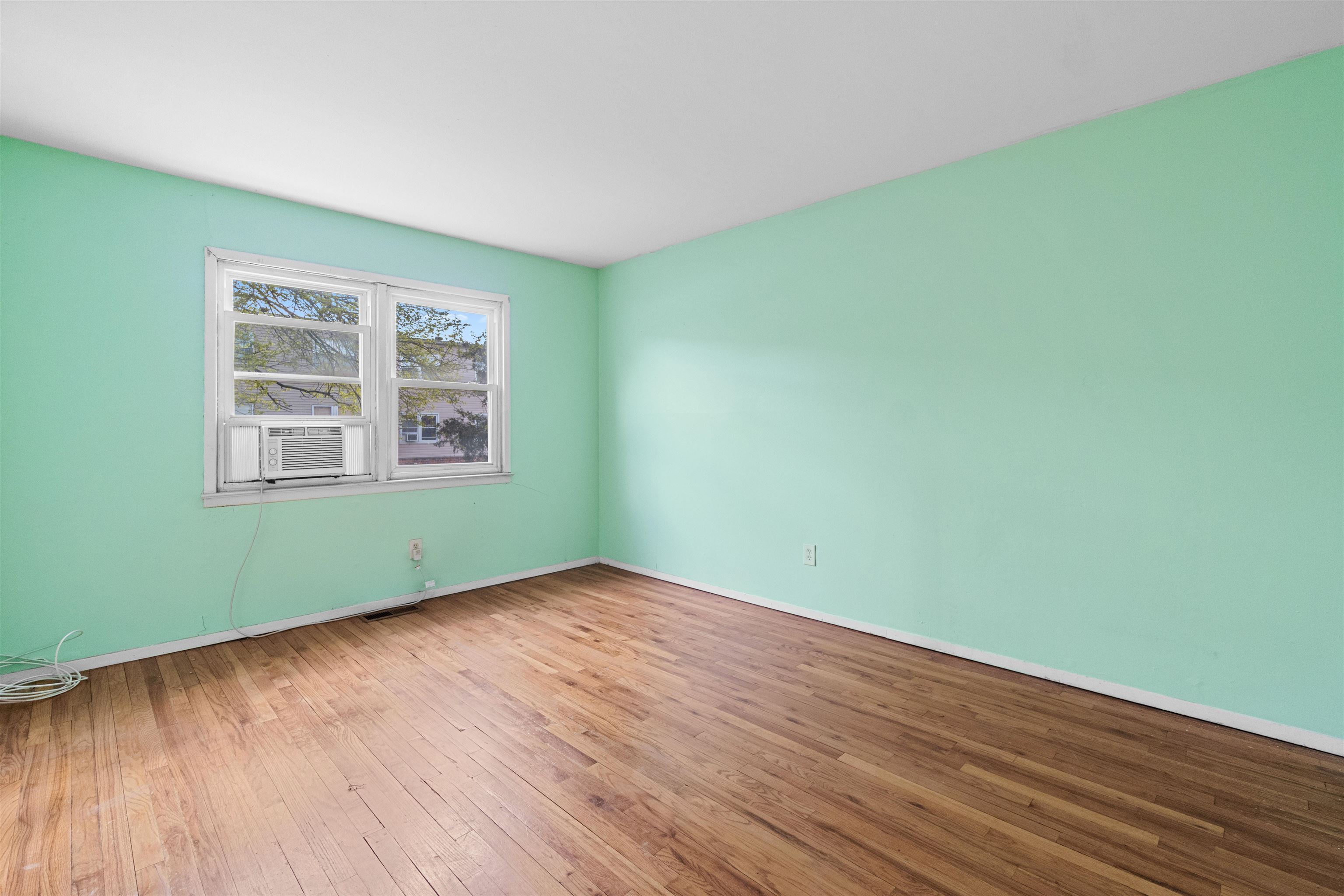 13 Crossgate Road Jersey City, NJ 07305 - Photo 8 of 36 an empty room with wooden floor and windows