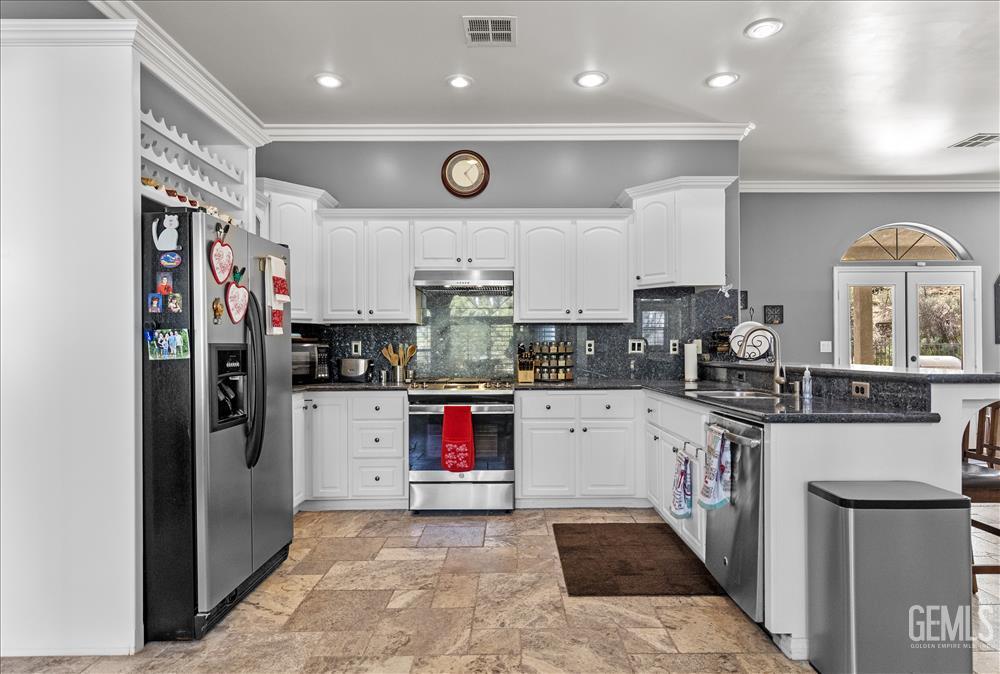 Undisclosed Address Tehachapi, CA 93561 - Photo 13 of 68 a kitchen with stainless steel appliances granite countertop a refrigerator and a stove top oven