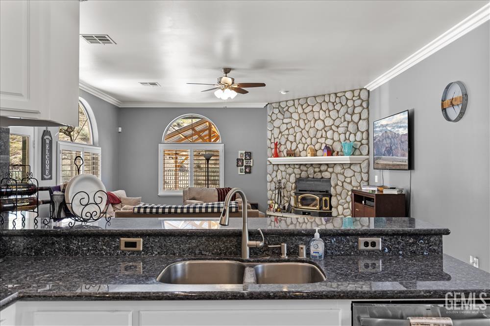 Undisclosed Address Tehachapi, CA 93561 - Photo 15 of 68 a kitchen with granite countertop a sink a stove and cabinets