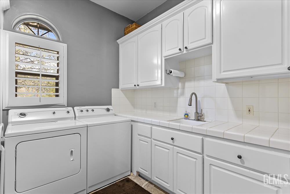 Undisclosed Address Tehachapi, CA 93561 - Photo 20 of 68 a utility room with cabinets washer and dryer