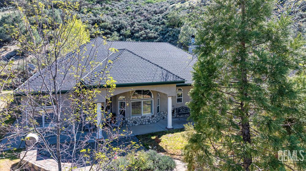 Undisclosed Address Tehachapi, CA 93561 - Photo 2 of 68 a front view of a house with a yard and large trees