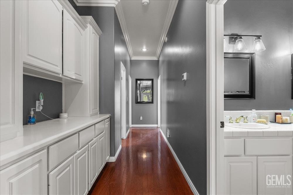 Undisclosed Address Tehachapi, CA 93561 - Photo 25 of 68 a view of hallway with cabinets and wooden floor