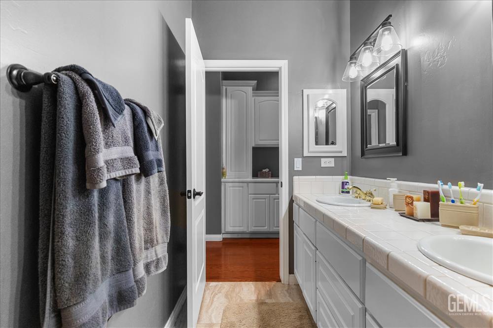Undisclosed Address Tehachapi, CA 93561 - Photo 27 of 68 a bathroom with a sink a mirror and a shower