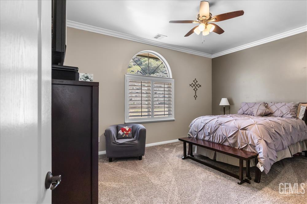 Undisclosed Address Tehachapi, CA 93561 - Photo 30 of 68 a spacious bedroom with a bed and a chandelier