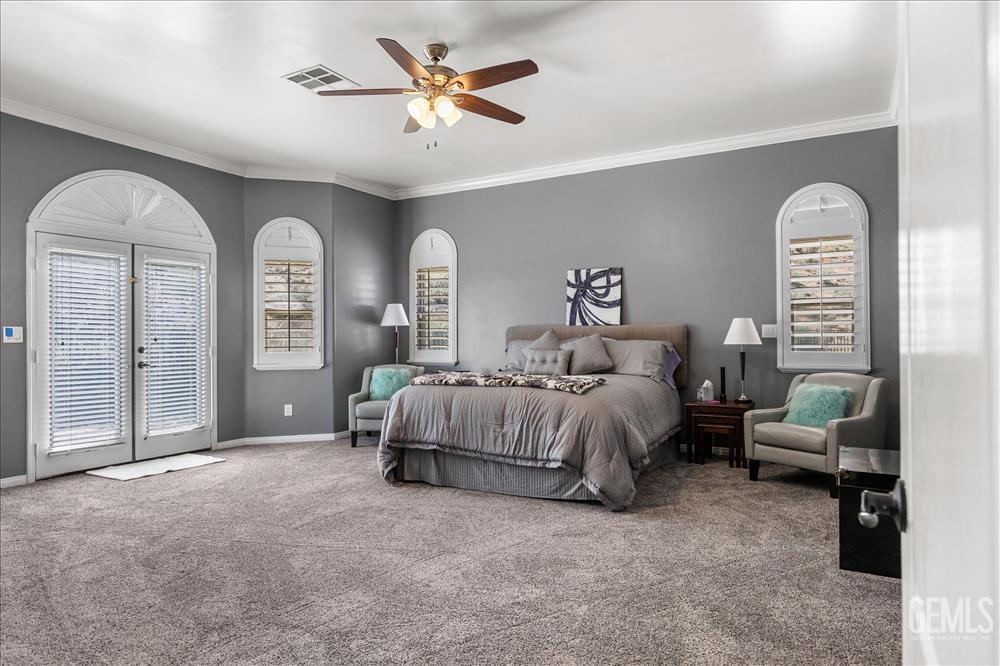 Undisclosed Address Tehachapi, CA 93561 - Photo 33 of 68 a spacious bedroom with a bed and a chandelier