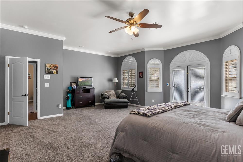 Undisclosed Address Tehachapi, CA 93561 - Photo 34 of 68 a bedroom with a large bed and a chandelier