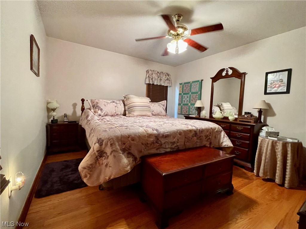 66119 Highway 124 Reedsville, OH 45772 - Photo 11 of 29 Bedroom with light hardwood floors and ceiling fan