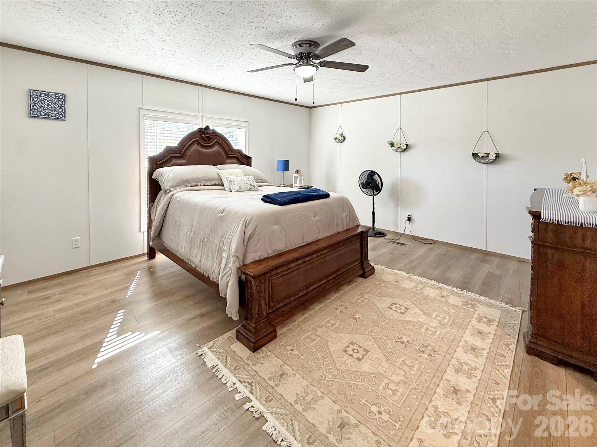 264 Fairchase Circle Stony Point, NC 28678 - Photo 11 of 24 a bedroom with a bed and a table with wooden floor