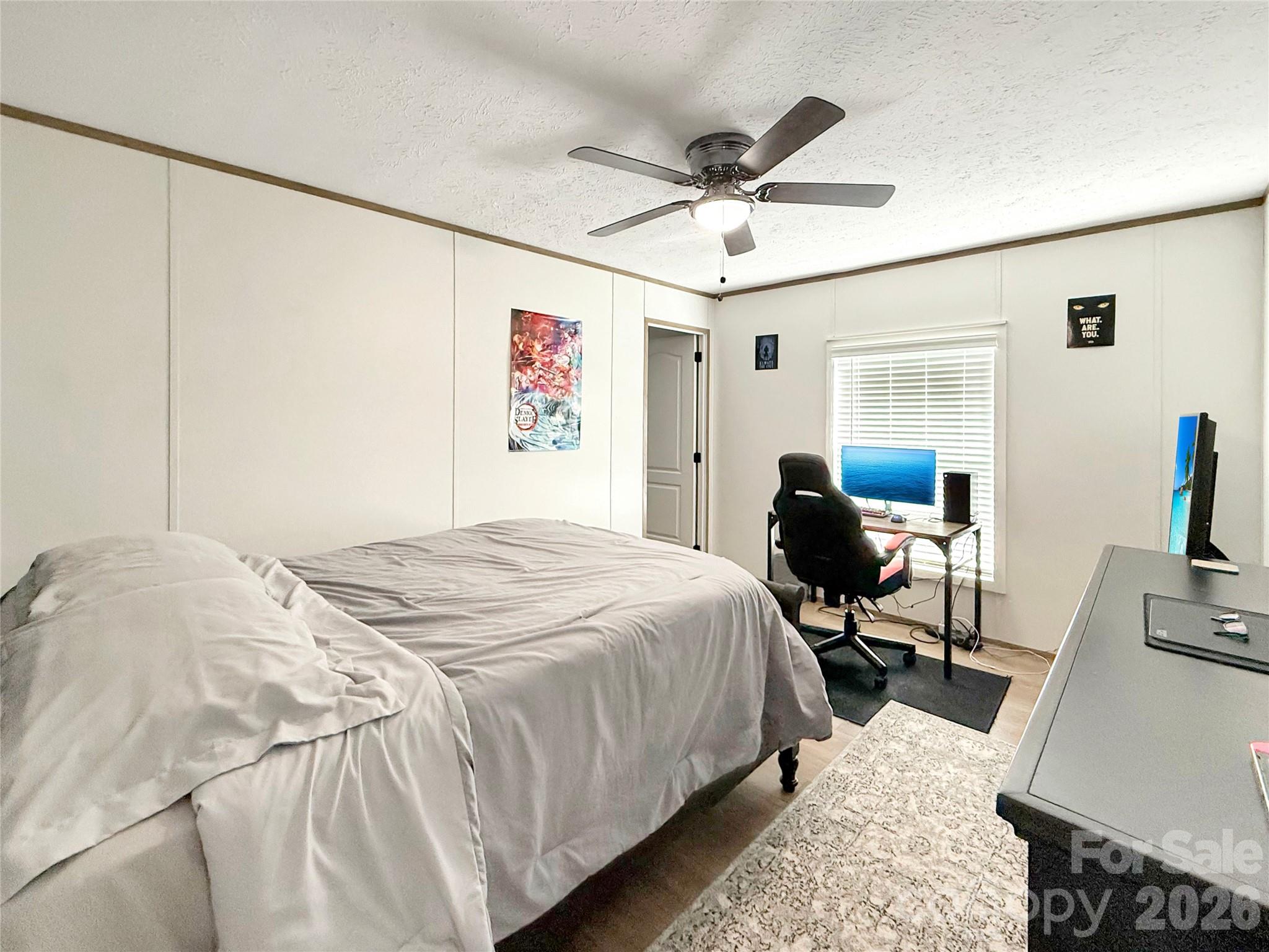 264 Fairchase Circle Stony Point, NC 28678 - Photo 15 of 24 a bedroom with a bed and a chandelier