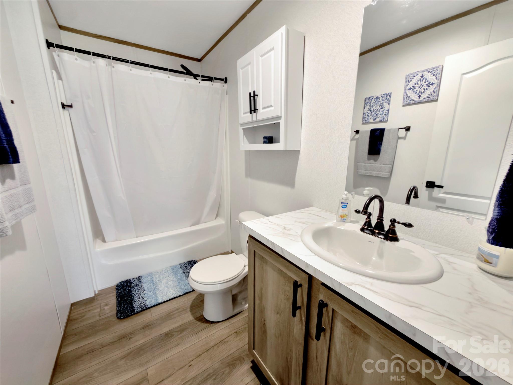 264 Fairchase Circle Stony Point, NC 28678 - Photo 17 of 24 a bathroom with a sink toilet a mirror and shower