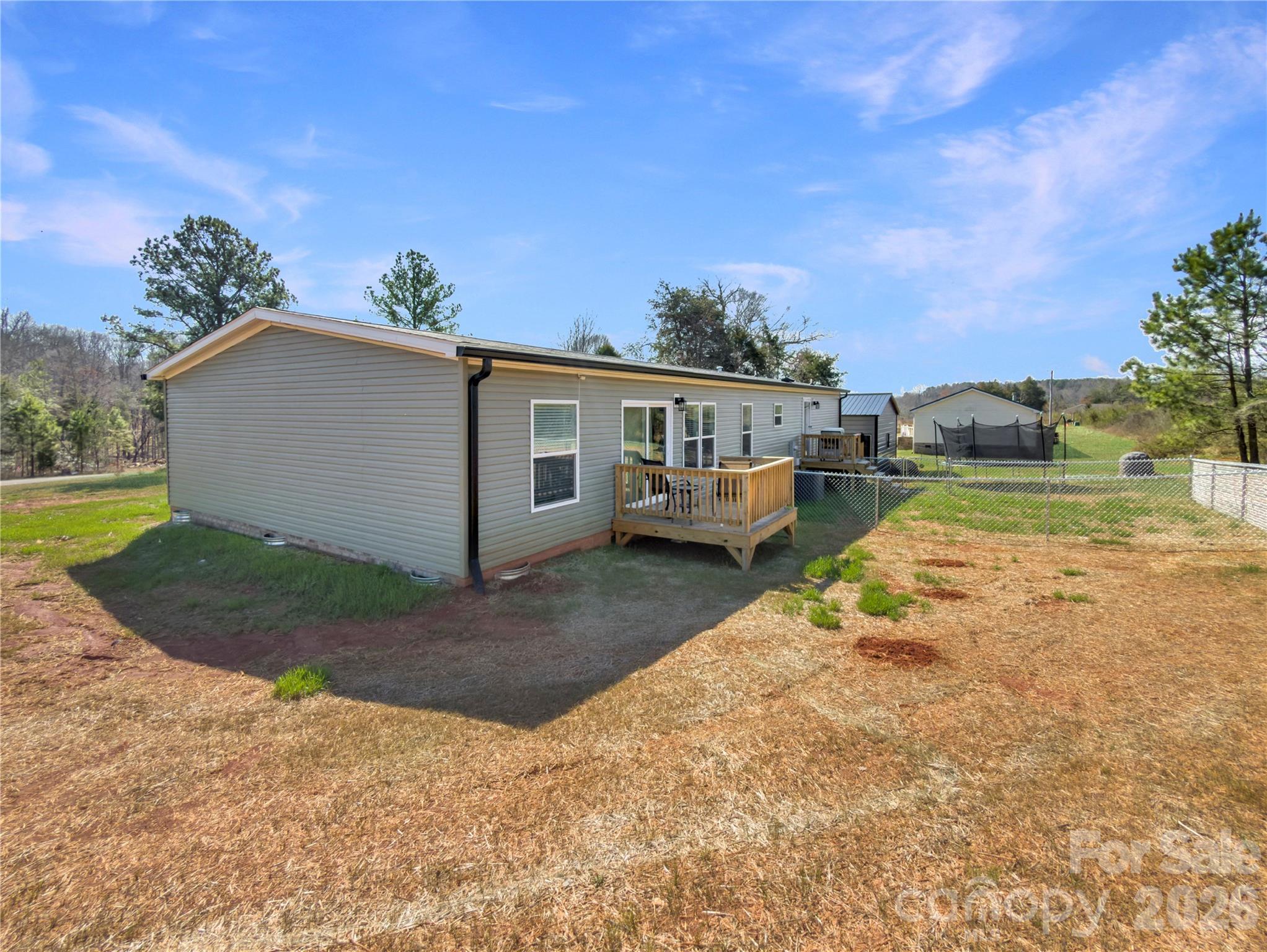 264 Fairchase Circle Stony Point, NC 28678 - Photo 22 of 24 a view of a house with a yard and a garden