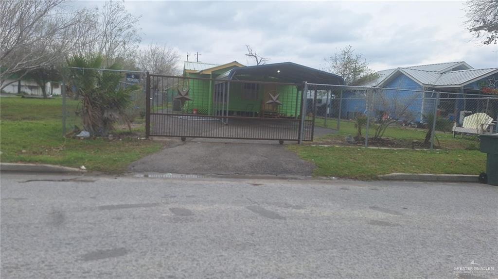 View of gate featuring a lawn