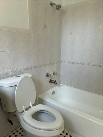 a bathroom with a toilet and a bathtub