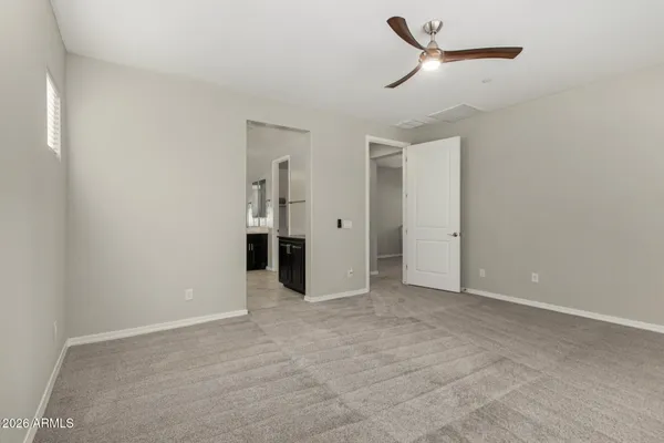 a view of an empty room with a ceiling fan