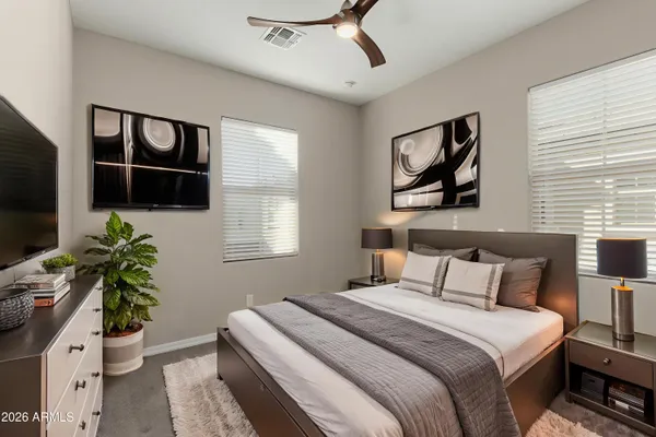 a bedroom with a bed and a flat screen tv