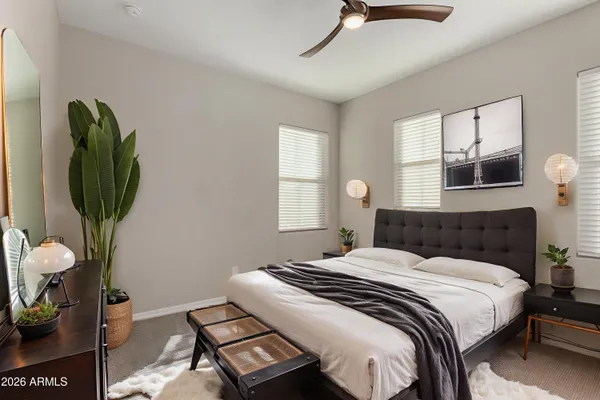 a bedroom with a bed a mirror and a window