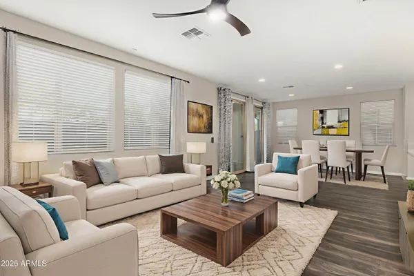 a living room with furniture and wooden floor
