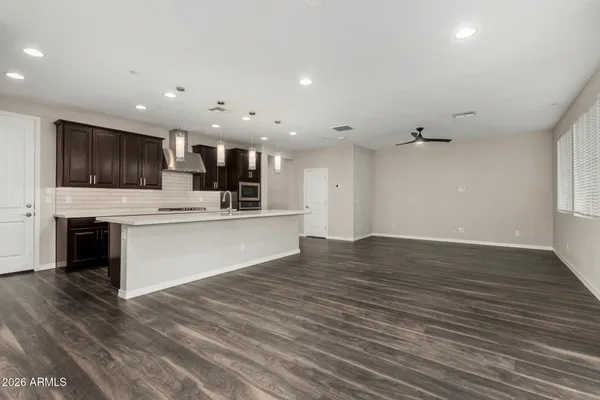 a view of kitchen with granite countertop cabinets stainless steel appliances and a fireplace