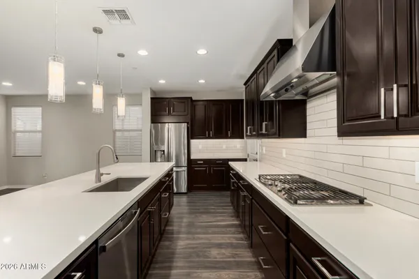 a kitchen with stainless steel appliances granite countertop a sink and stove