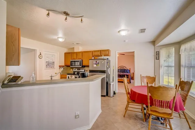 a kitchen with stainless steel appliances a stove a microwave and cabinets